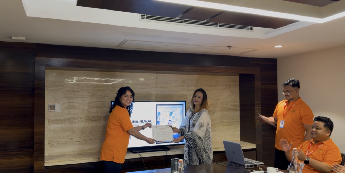 Recognition certificate handover to a team member.